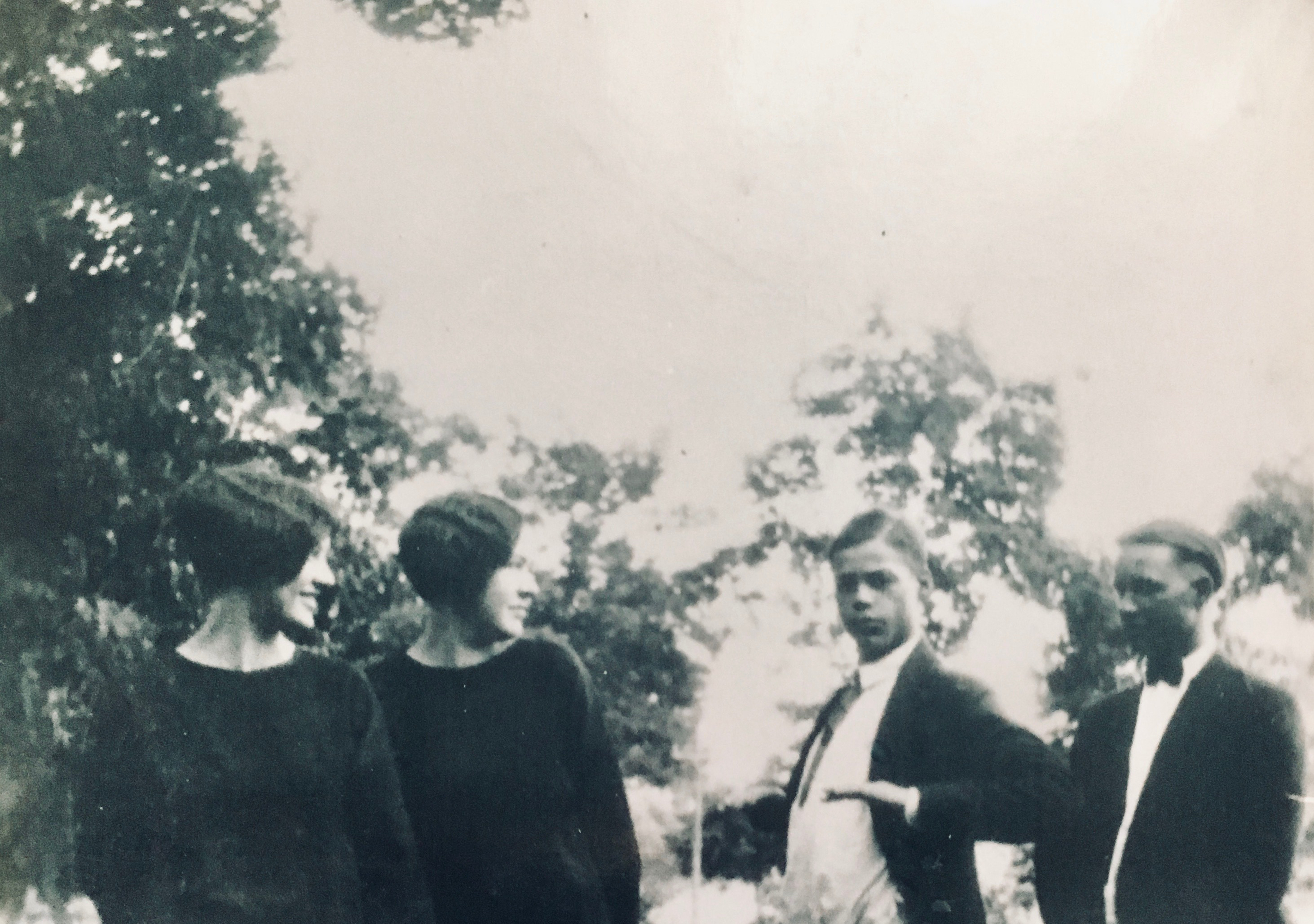 Two young ladies and two young men in funeral attire.